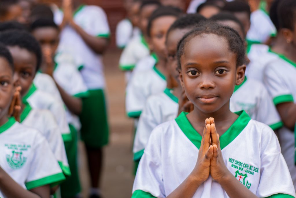 Students gathered at the assembly grounds, participating in morning devotion and school announcements in a disciplined and vibrant environment.