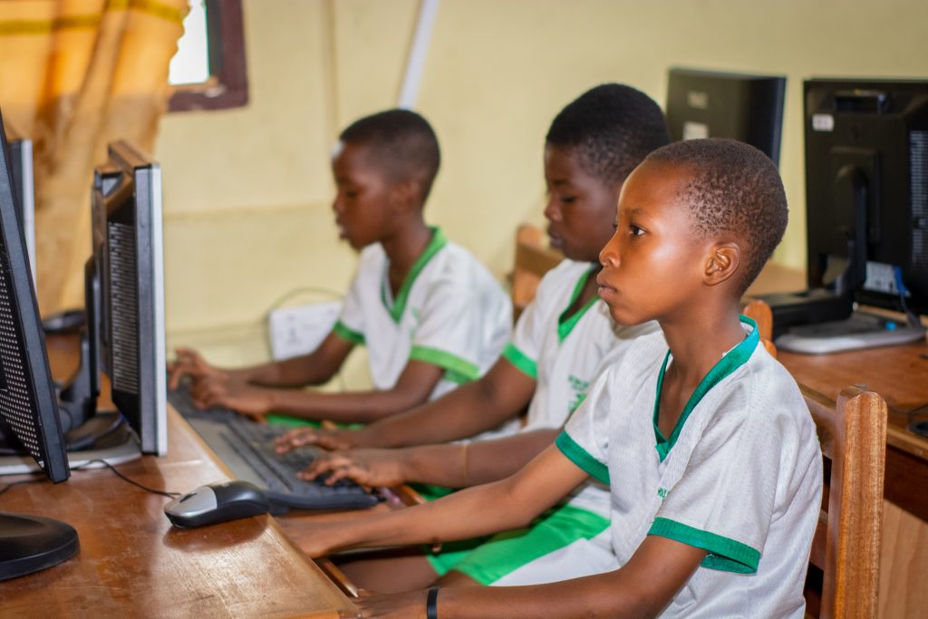 Students in the ICT lab engaging in hands-on computer learning, developing digital skills in a modern, well-equipped environment.
